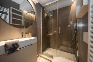 a bathroom with a shower and a sink and a mirror at Casa del Carro 2 Grand Terrace Apartment in Venice +25 photos