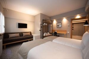 a hotel room with a white bed and a couch at Casa del Carro 2 Grand Terrace Apartment in Venice +25 photos