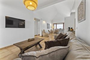 a living room with a couch and a table at Villa 22 in Tías