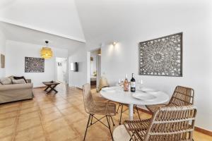 a dining room and living room with a table and chairs at Villa 22 in Tías