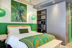 a bedroom with a bed and a green wall at WEX1 Private Apartments by Perch Stays in Cape Town