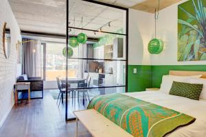 a bedroom with a bed and a dining room at WEX1 Private Apartments by Perch Stays in Cape Town