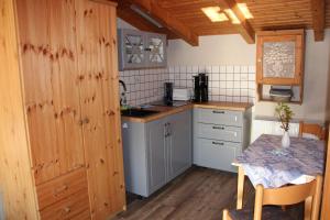 a small kitchen with a table in a room at Oberdeck in Dierhagen