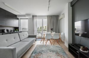 New Praga Urban Modern Apartment في وارسو: غرفة معيشة مع أريكة وطاولة