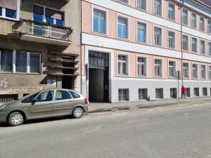 a car parked on a street next to a building at Mojmirova Apartment Kosice Center in Košice