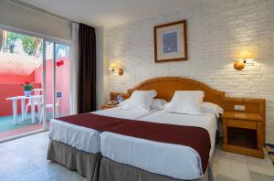 Postel nebo postele na pokoji v ubytování Hotel MS Tropicana