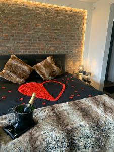 a bedroom with a bed with a brick wall at Suite Tino in Verviers