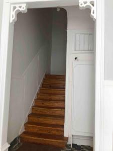 a hallway with a staircase with wooden floors and a door at Angels Homes-n27, 2ºfloor - Bairro Tipico, Centro Lisboa in Lisbon