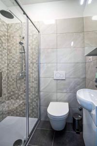a bathroom with a shower and a toilet and a sink at Seafront 2-bedroom apartment Nika - Rabac in Rabac