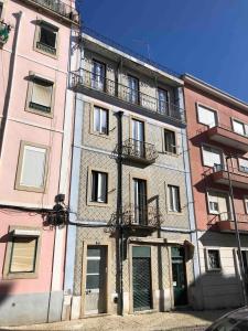 - un grand bâtiment avec des balcons sur le côté dans l'établissement Angels Homes-n27, 2ºfloor - Bairro Tipico, Centro Lisboa, à Lisbonne