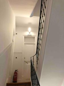 a staircase with a light and a white door at Angels Homes-n27, 2ºfloor - Bairro Tipico, Centro Lisboa in Lisbon