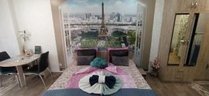 a bedroom with a bed with a view of the eiffel tower at Velvita Central in Sliven