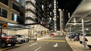 a parking lot with cars parked in front of a building at Sandakan Homestay Sea-Forest View Apartment 2R2B 海森雙景公寓 in Sandakan