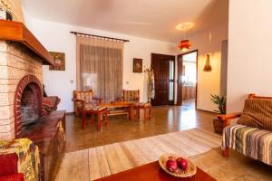 a living room with a couch and a fireplace at Alonia Summerhouse in Fanes in Fánai