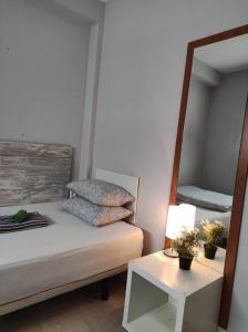 a bedroom with a bed with a mirror and a table at 38 - Habitacion en piso in Alicante