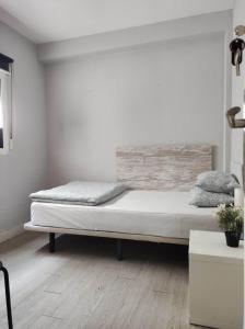 a white bedroom with a bed in a room at 38 - Habitacion en piso in Alicante