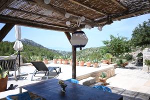 a patio with a table and chairs and mountains in the background at Agave in Veliko Grablje +34 photos