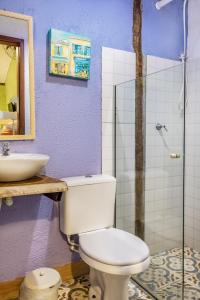 a bathroom with a toilet and a sink at Vilarejo do Perequê in Ilhabela