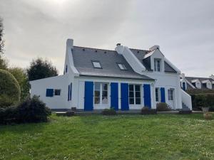 ein weißes Haus mit blauem Trimm auf einem Hof in der Unterkunft Maison Le Palais, 5 pièces, 8 personnes - FR-1-418-3 in Le Palais