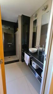 a bathroom with a sink and a mirror at Villa Albertina HOUSE-Villa María in Villa María