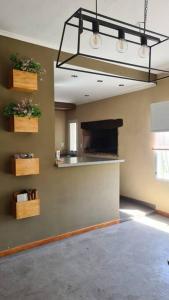 a living room with a kitchen with a fireplace at Villa Albertina HOUSE-Villa María in Villa María