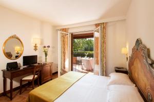 Postel nebo postele na pokoji v ubytování Fattoria La Principina Hotel & Congress
