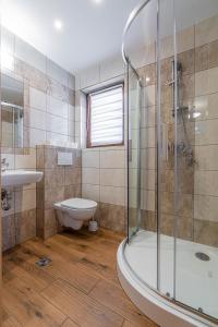 a bathroom with a shower and a sink and a toilet at Widokowe Domki Gawlaki in Zakopane +63 photos