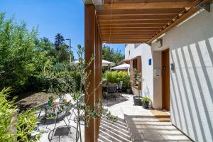 an external view of a house with a wooden pergola at Stay U-nique Studio apartment in Orašac in Orasac