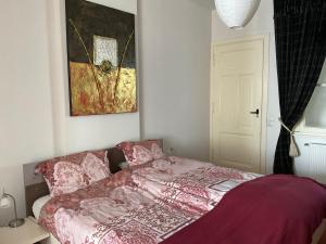 a bedroom with a bed and a painting on the wall at inn Venlo Apartment in Venlo +12 photos