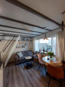 a living room with a couch and a table at Zomerhuis Tuls in Egmond aan Zee