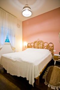 a bedroom with a white bed and a window at lotus beach house in H̱adera