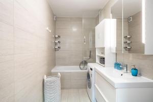 a bathroom with a sink and a washing machine at Stay U-nique Studio apartment in Orašac in Orasac +36 photos