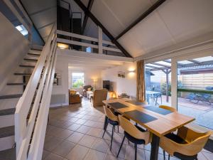 a dining room and living room with a table and chairs at Westenwind 3 - Holiday house parking - floor 0 in Middelkerke