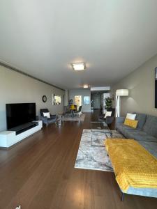 a living room with a couch and a flat screen tv at Madeira Palace Residences in Funchal