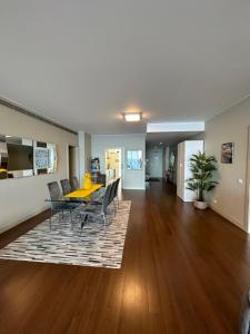 a dining room and living room with a table and chairs at Madeira Palace Residences in Funchal