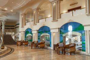 a lobby with chairs and a mural on the wall at Life Resorts Coral Hills Beach & SPA in Quseir