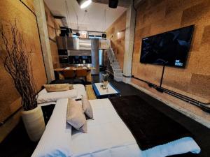 Habitación con 2 camas y TV de pantalla plana. en VibesCoruña - Loft Industrial Comercio, en A Coruña