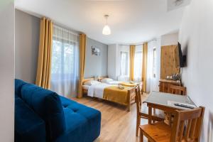 Posteľ alebo postele v izbe v ubytovaní Maya Pokoje i Apartamenty