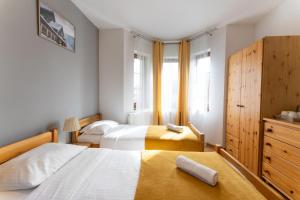 Posteľ alebo postele v izbe v ubytovaní Maya Pokoje i Apartamenty