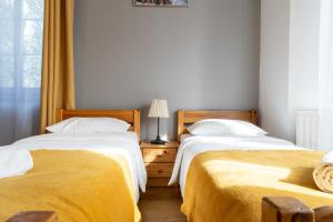 Posteľ alebo postele v izbe v ubytovaní Maya Pokoje i Apartamenty