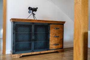 a wooden cabinet with a camera on top of it at Maya Pokoje i Apartamenty in Karpacz