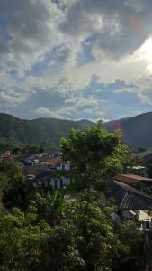 a view of a city with trees and buildings at Foggy Mount View in Bandarawela