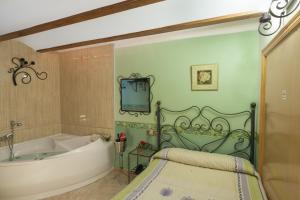 a bathroom with a tub and a sink and a bath tub at Pension San Jose in Bullas