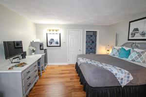 a bedroom with a bed and a desk with a television at Colonial Inn Seekonk in Seekonk