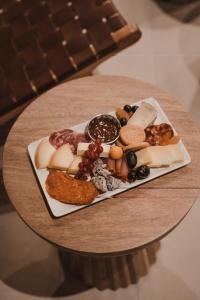 a plate of appetizers on a wooden table at Kimpton Aysla Mallorca by IHG in Santa Ponsa