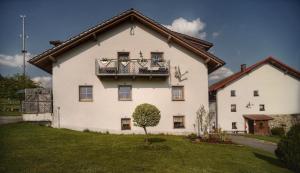 a large white house with a balcony on it at Ferienwohnung Mirtei in Hohenau