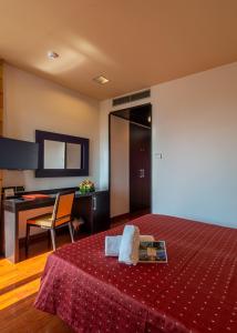 una camera d'albergo con letto e scrivania di Victoria Terme Hotel a Tivoli Terme