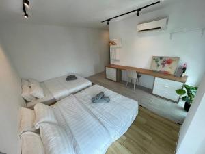 a white room with two beds and a desk at 3bedroom Sutera Avenue Kota Kinabalu by Twen8ty Homestay in Kota Kinabalu