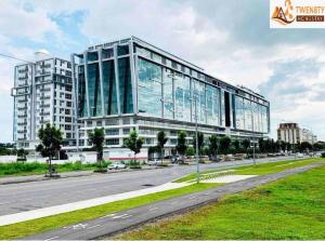 a large glass building on the side of a road at 3bedroom Sutera Avenue Kota Kinabalu by Twen8ty Homestay in Kota Kinabalu