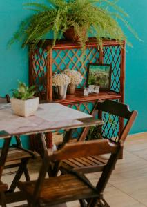 a table and a chair in a room with a blue wall at Pousada Rosa do Mar in Gamboa +50 photos